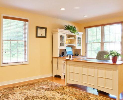 Bright office interior with large area rug and desk