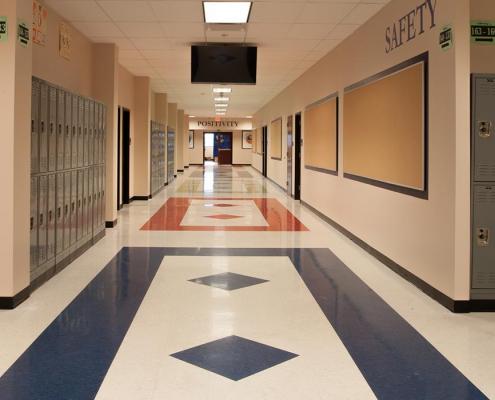 Charter school construction. Wide school hallway with bulletin boards and lockers