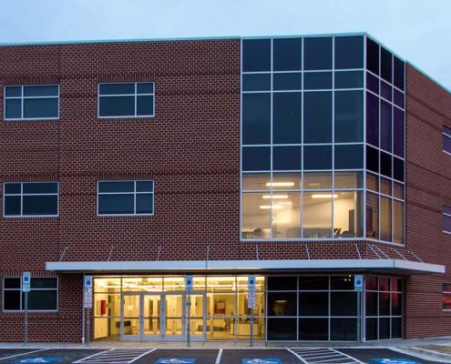 Education construction. School building exterior of brick and glass