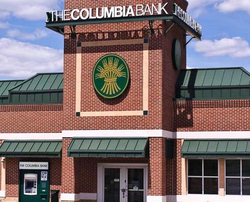 Bank building construction featuring brick exterior with drive-thru