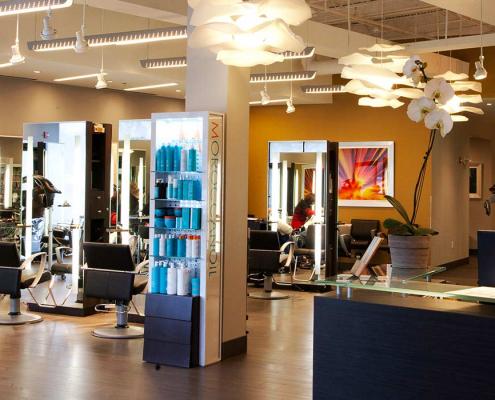 Interior construction of salon by KasCon. View past reception area into hair salon showing individual stations