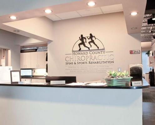 Close-up of reception desk with Howard County Chiropractic custom signage