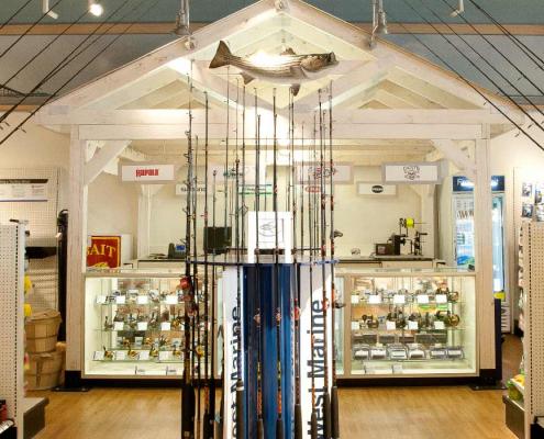 Interior retail construction showing fishing rod and lures display